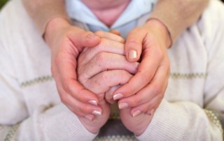 Alzheimer-long-term-care-holding-hands