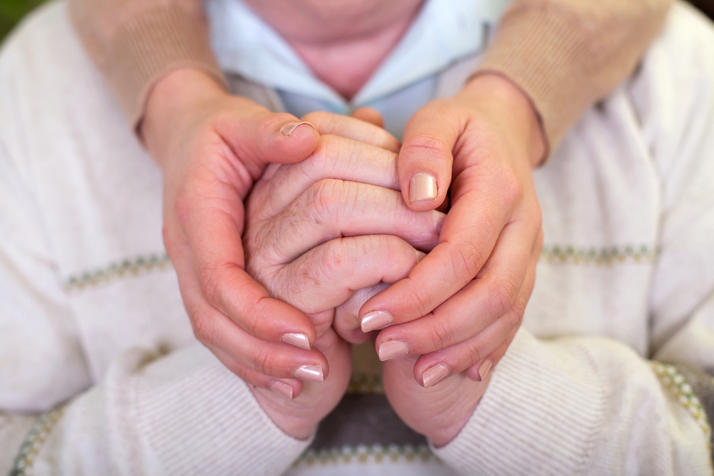 Alzheimer-long-term-care-holding-hands
