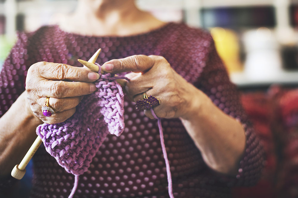 Close up of senior woman's hands knitting