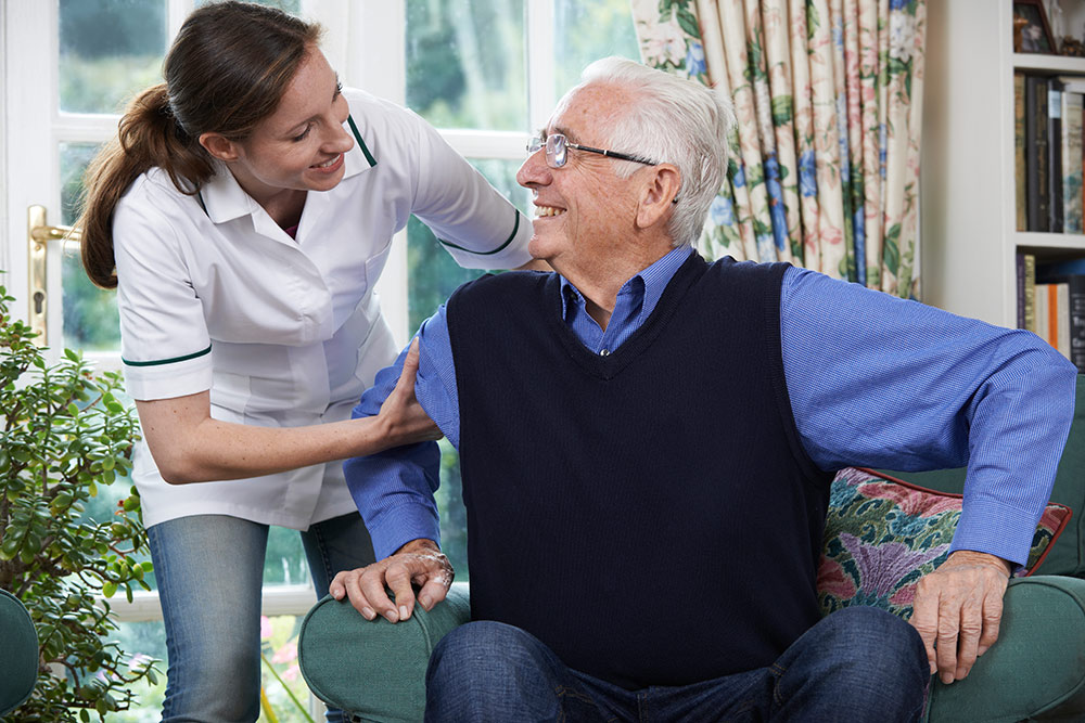 Senior man with nurse, caregiver in assisted living