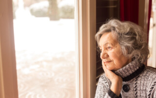 A senior woman looking out the window
