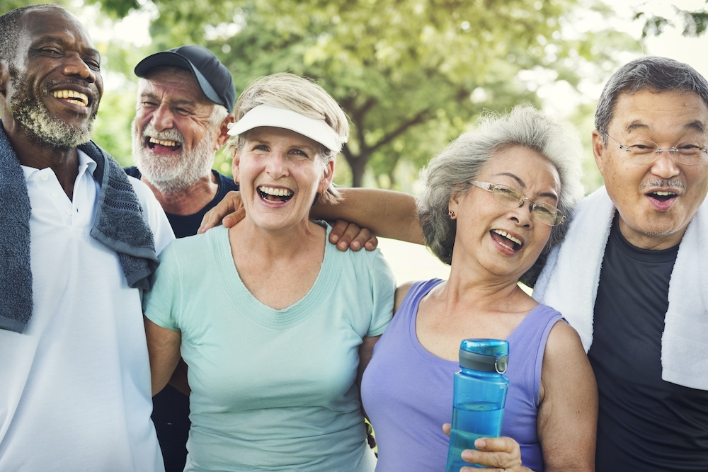 A group of happy, active seniors laugh and hang out