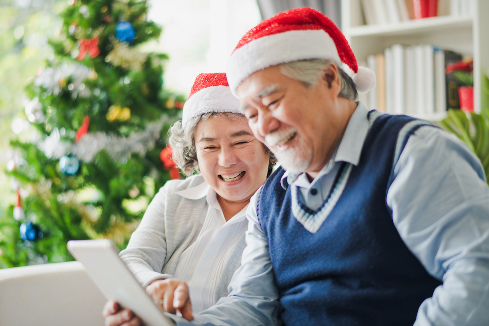 Seniors in assisted living use a tablet to talk with family members for the holidays