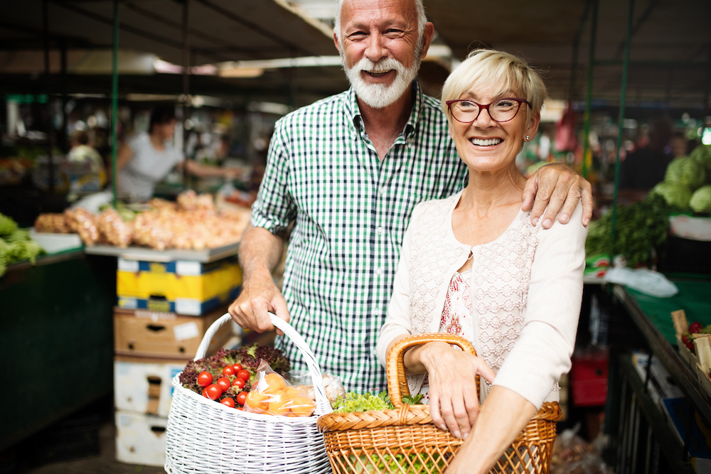 A senior couple out shopping at a farmer's market