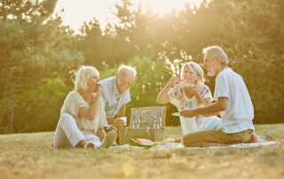 A group of seniors enjoy an outdoor picnic