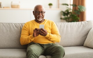 A senior man uses social media on his smart phone