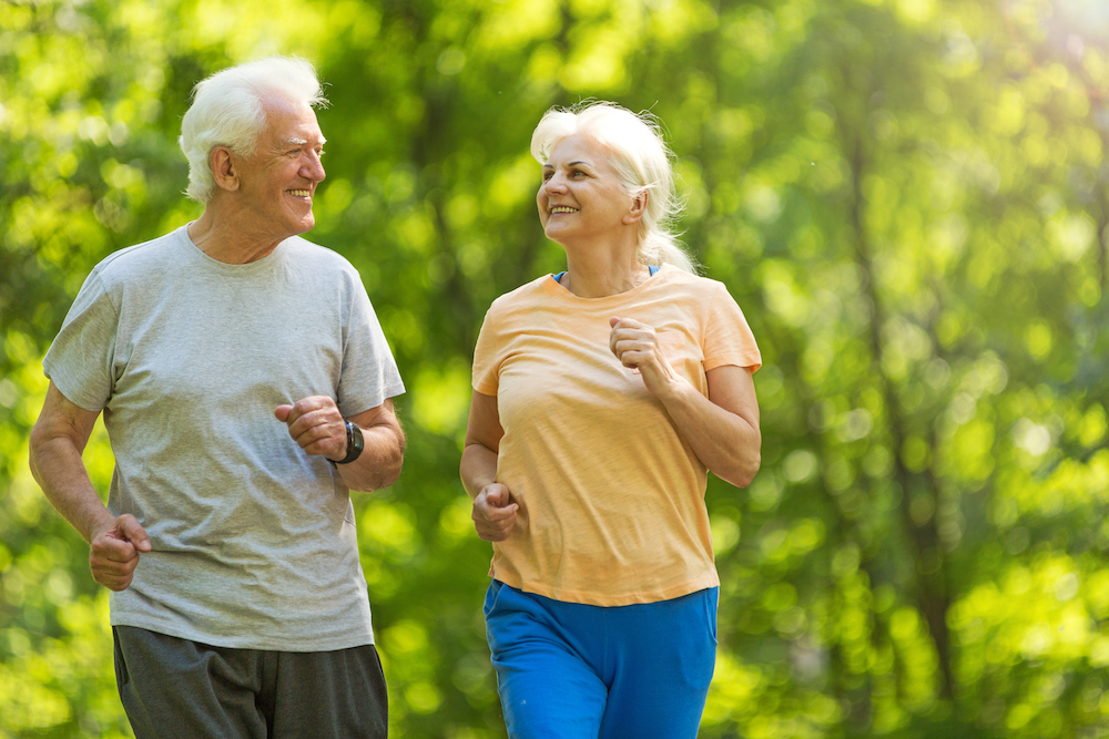 Two residents from senior assisted living facilities go for a jog outdoors
