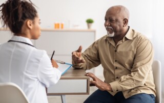 A senior man talks with his doctor